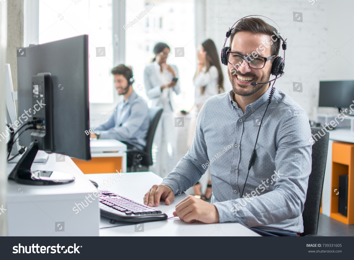 stock-photo-happy-young-male-customer-support-executive-working-in-office-739331605